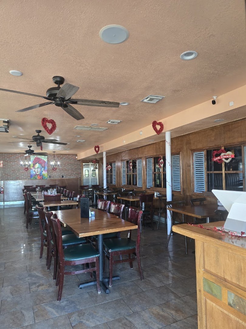 Casual interior with a bar and table service.